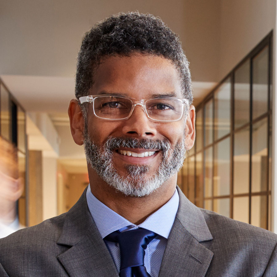 portrait of middle aged black man in a busy modern PZEKYNB